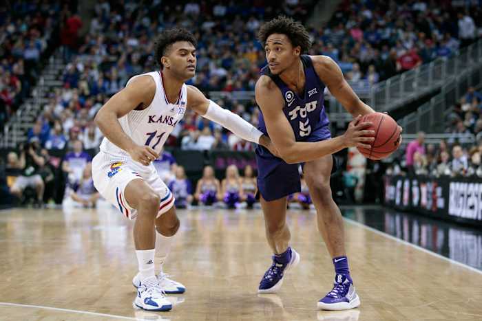 Mar 11, 2022; Kansas City, MO, USA; TCU Horned Frogs forward Chuck O'Bannon Jr. (5) looks to get around Kansas Jayhawks guard Remy Martin (11) during the first half at T-Mobile Center. Mandatory Credit: William Purnell-USA TODAY Sports
